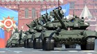 Tanks parade in Red Square in front of a communist banner