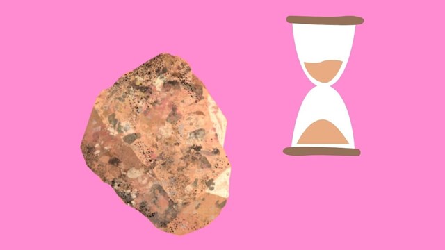 A chunk of the pink Pikes Peak granite is shown beside an hourglass.