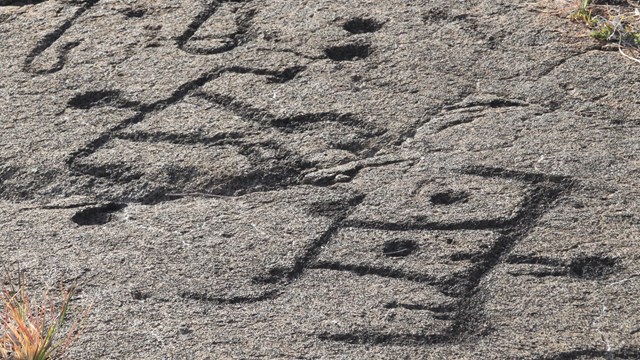 Petroglyph field with a rainbow in the distance