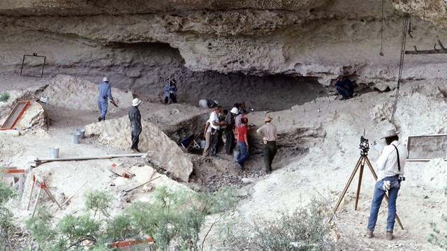 Lower Pecos Canyonlands Archeological District dig site surrounded by archaeologists at work.