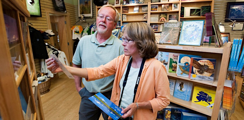 Man and woman browsing postcards in a bookstore