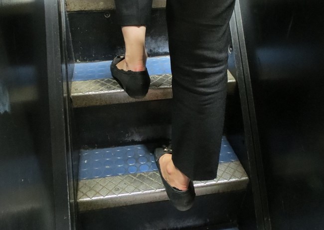 A visitors foot showing the dimensions of the stairs walking up to the crown.