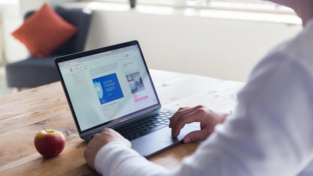 Person sits at laptop on table