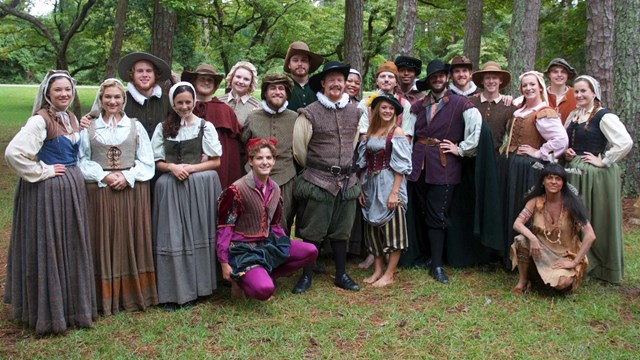 group of individuals in period dress standing together