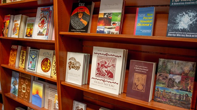 Book shelf lined with books about Hawaiian culture and history