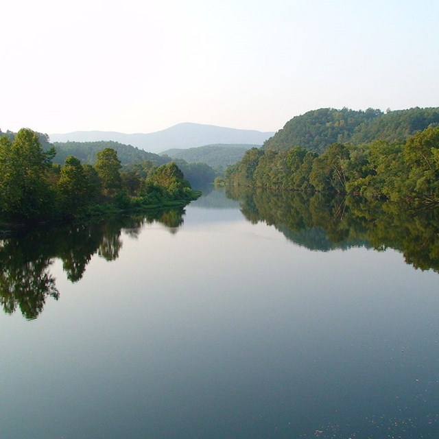 image of river with mountains in background. CC0.