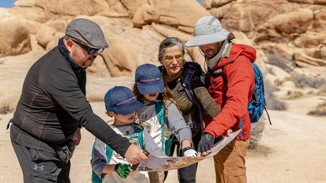 A group of people looking over a map