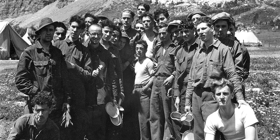 historic black and white photo of a group of CCC boys at a tent camp.