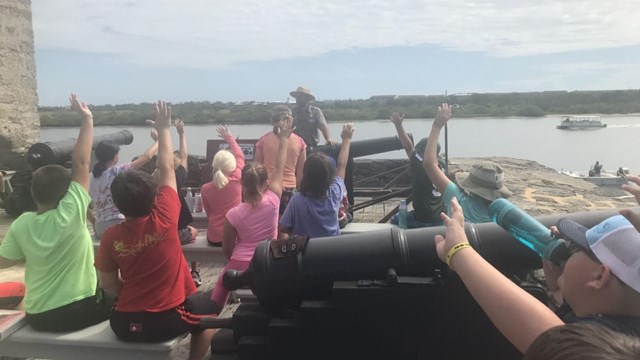 Group of students with a ranger on the gun deck. 