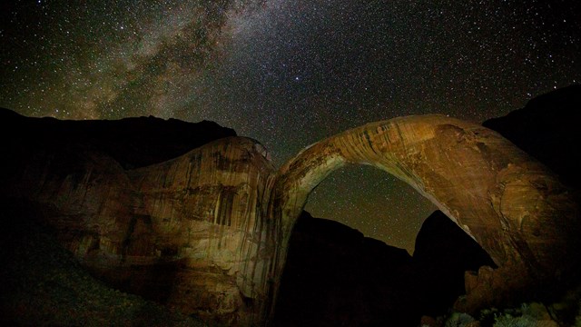 Milky Way above eerily lit Rainbow Bridge