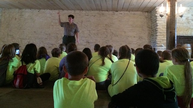 Park Ranger talking to student in the basement jail.