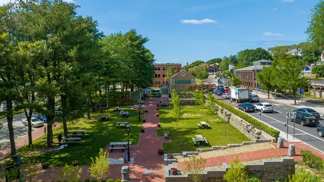 Parklands with picnic benches, paths, and visitor center