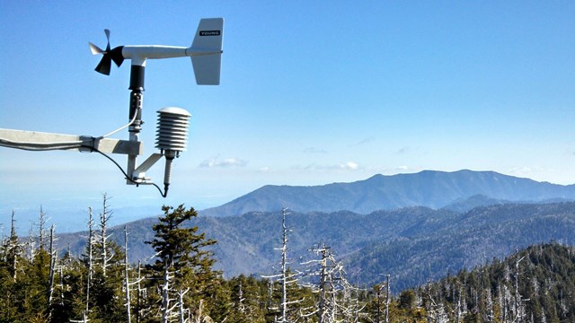 Wind vane in foreground with Smoky Mountain National Park in the background