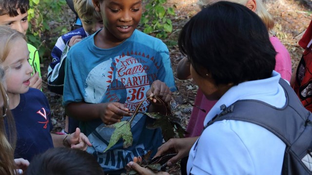 Park staff talks to children during outdoor program