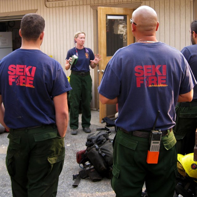 Firefighters listen to briefing before responding to a fire.