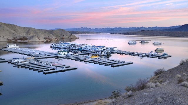 Sunset over a marina at a lake.