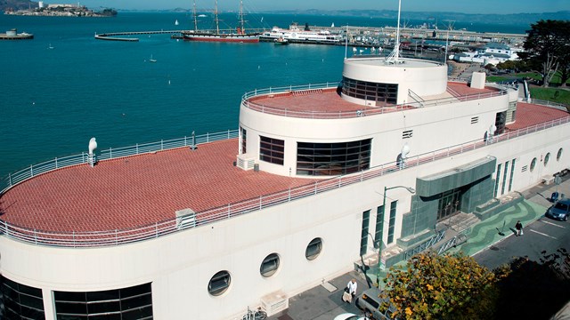 A building with a red roof and white sides.