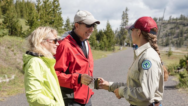 A pair of visitors interact with a social science surveyor