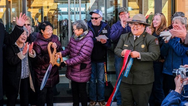 Group cutting a ribbon at a ribbon cutting ceremony