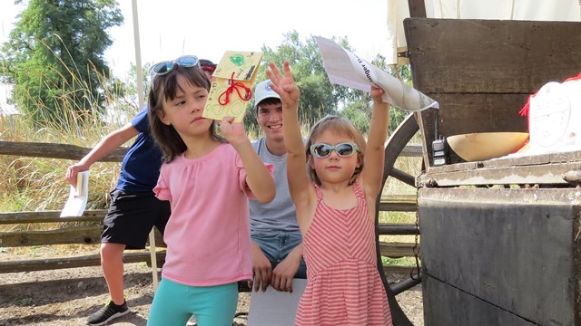 Two kids hold up a prize 