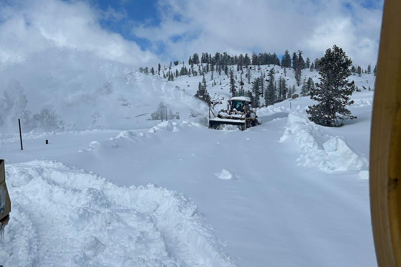 Blower plowing through several-foot-deep snow