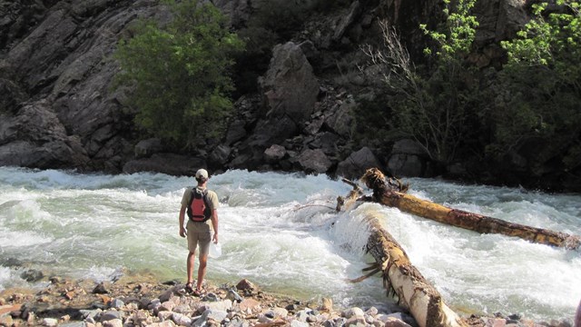 A lone hiker gazes at the Gunnison River in the Black Canyon Wilderness