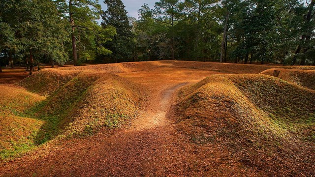 Reconstructed earthen fort covered in grass