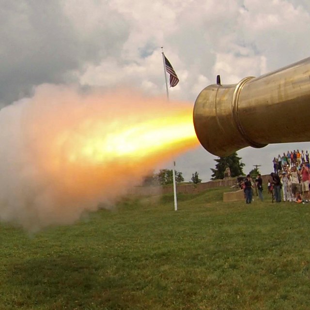 a canon firing; wagon wheel on left