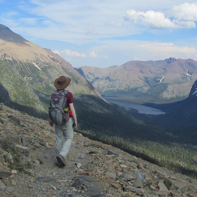 person walking toward glacial valley