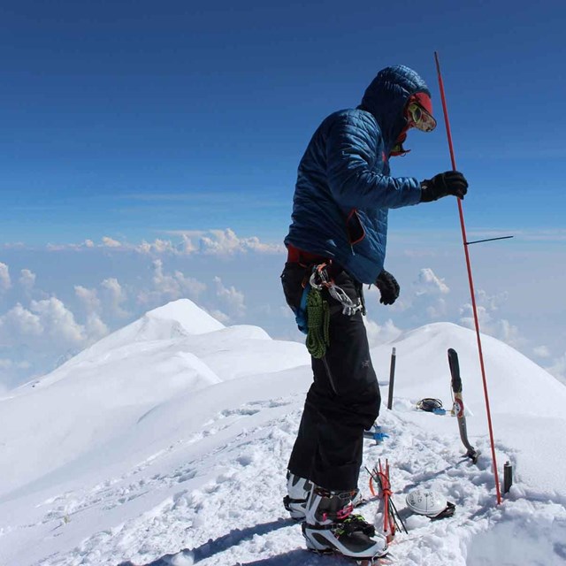 Scientists take measurements on a glacier.