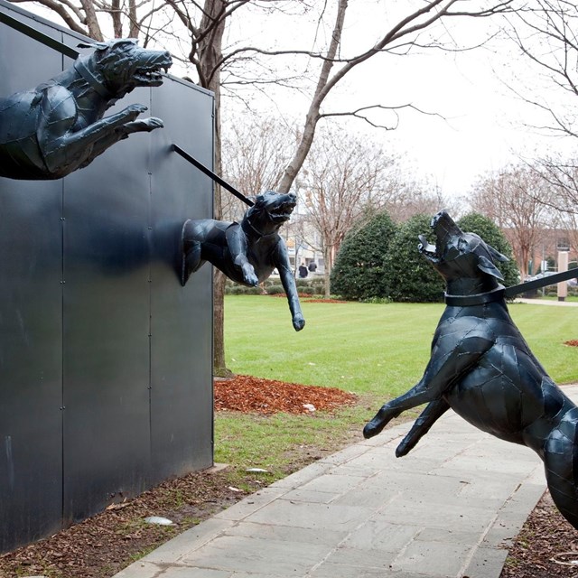 Statue of attack does snarling at each other across a sidewalk