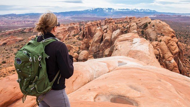 a hiker on a rock fin