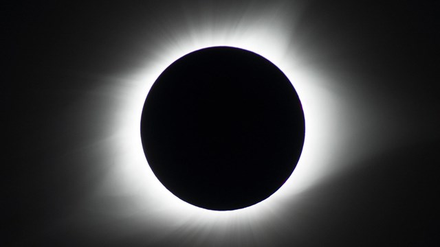 A ring of light from the sun is seen around the moon during a total solar eclipse.