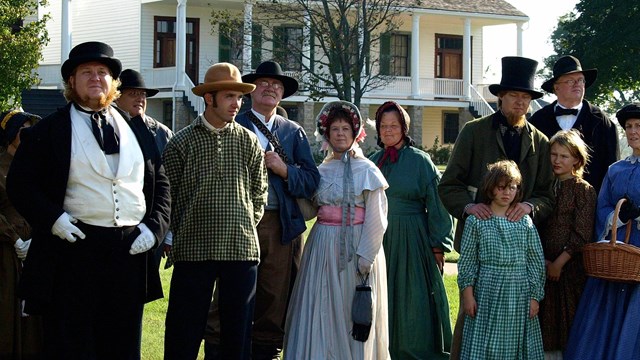 people dressed out in a scene where they are awaiting an auction