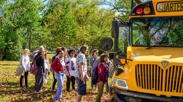 Kids loading onto a school bus.