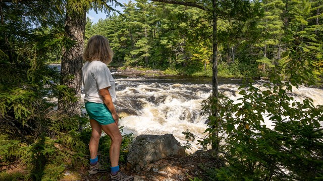 A woman marvels at the view of Grand Pitch (located in the East Branch of the Penobscot River).