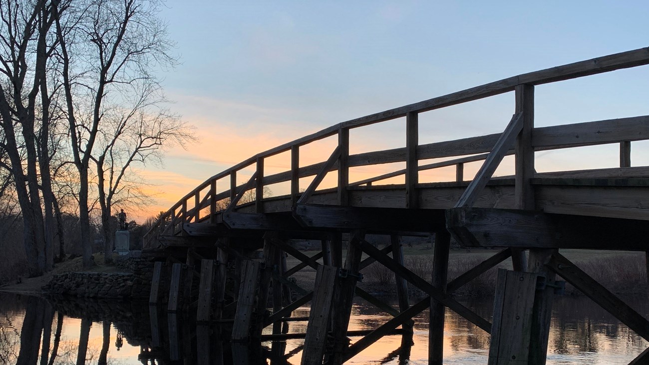 North Bridge timbers silhouetted against the sunset reflecting in the water.