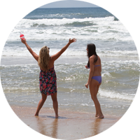 Two visitors enjoy the view as they stroll the beach