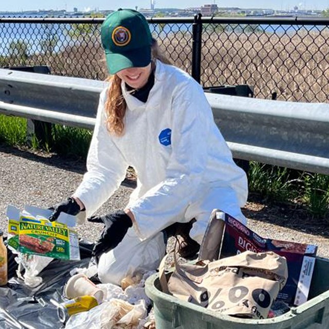 CCCC Intern cleaning up wetlands near Fort McHenry