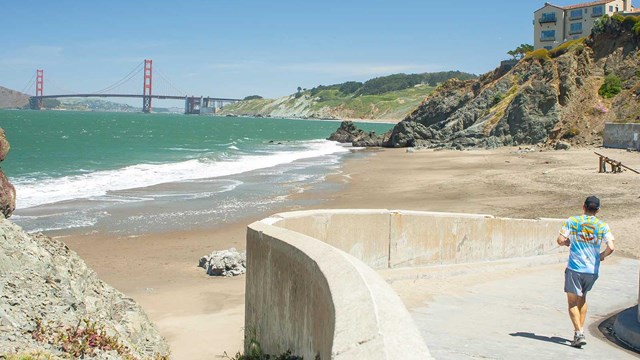 man jogging on trail leading to china beach shore