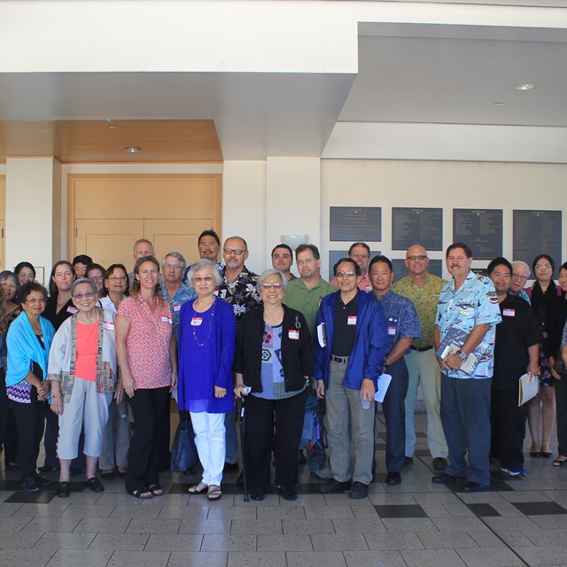 a large group of people standing in front of a building