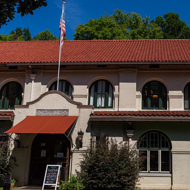 Looking at the Hale directly. It has a ceramic red roof, rounded windows, and a wooden door.