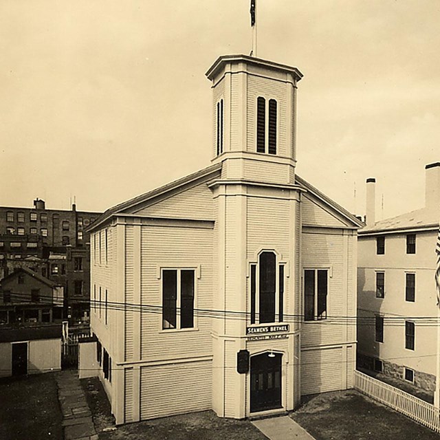 Historic sepia photo showing Seamen's Bethel and the Mariners' home on the right.