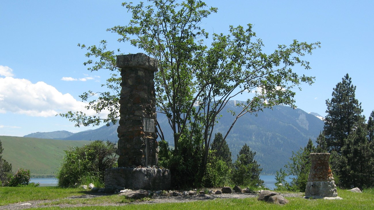 Large tombstone made of many rocks cobbled together.