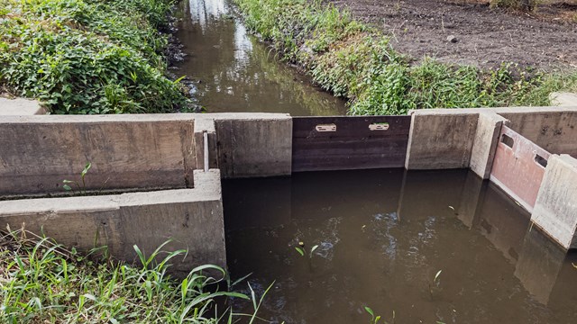 Sluice gate on irrigation ditch. 