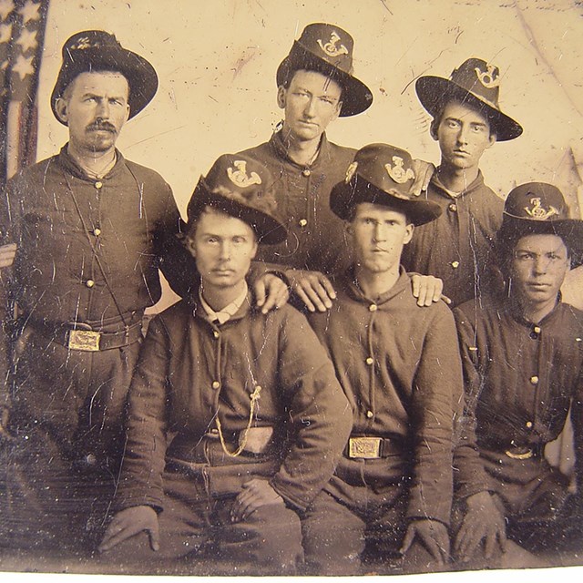 A group of men in uniform pose for an image 