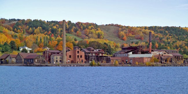 The Quincy Smelter surrounded by autumnal trees.