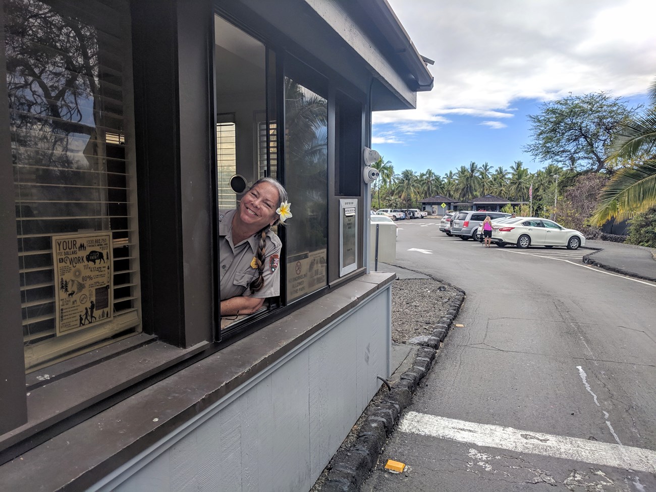 A ranger spreads aloha as she welcomes visitors to the park at the entrance station