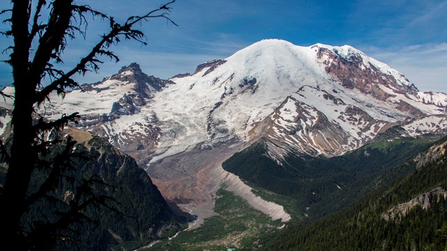 photo of a volcanic mountain with forested slopes