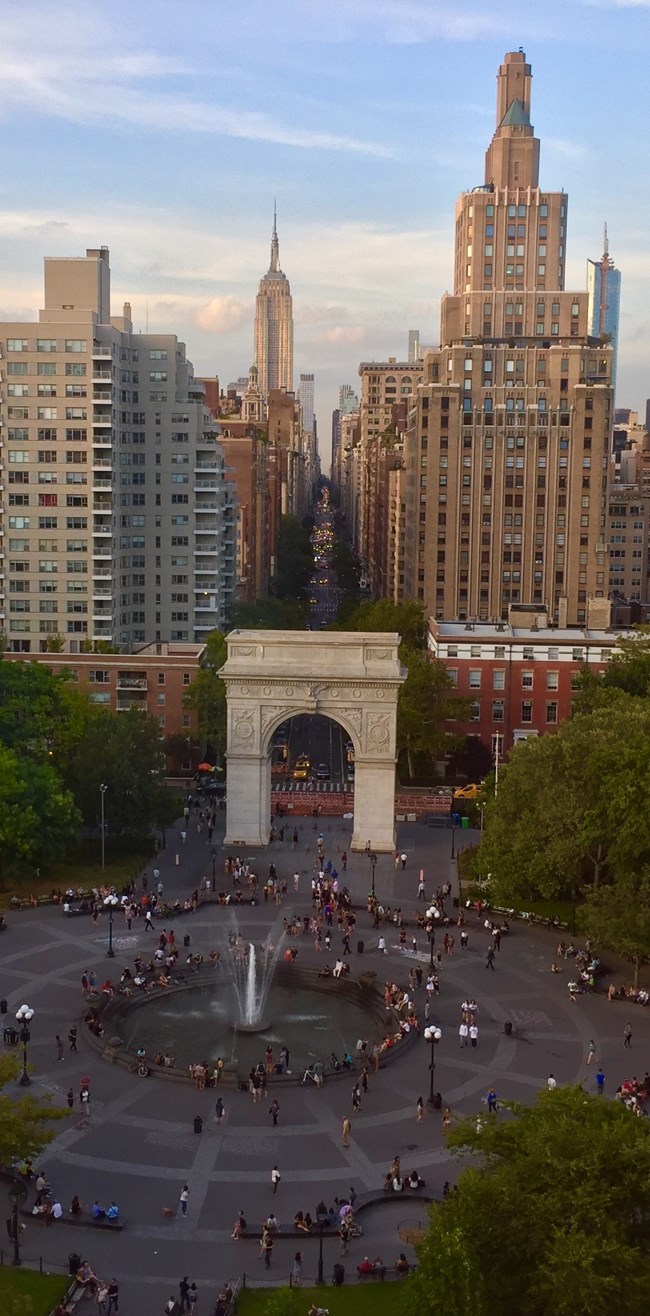 Arch in Washington Park with city in background. Photo by Isabella Ruffalo-Burgat, CC BY-SA 4.0